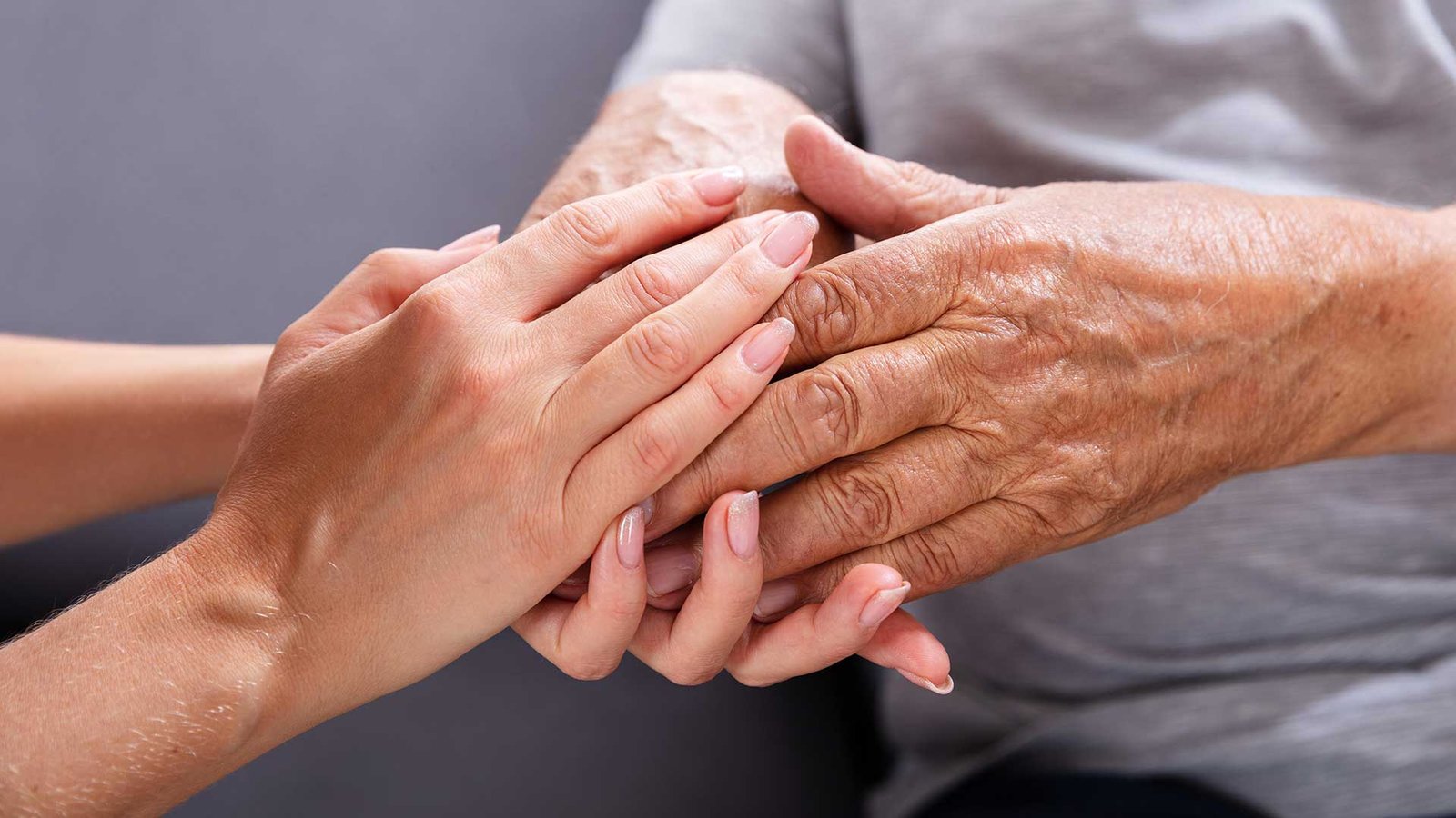 Caring hands supporting an elderly person — Elderly Homecare Services